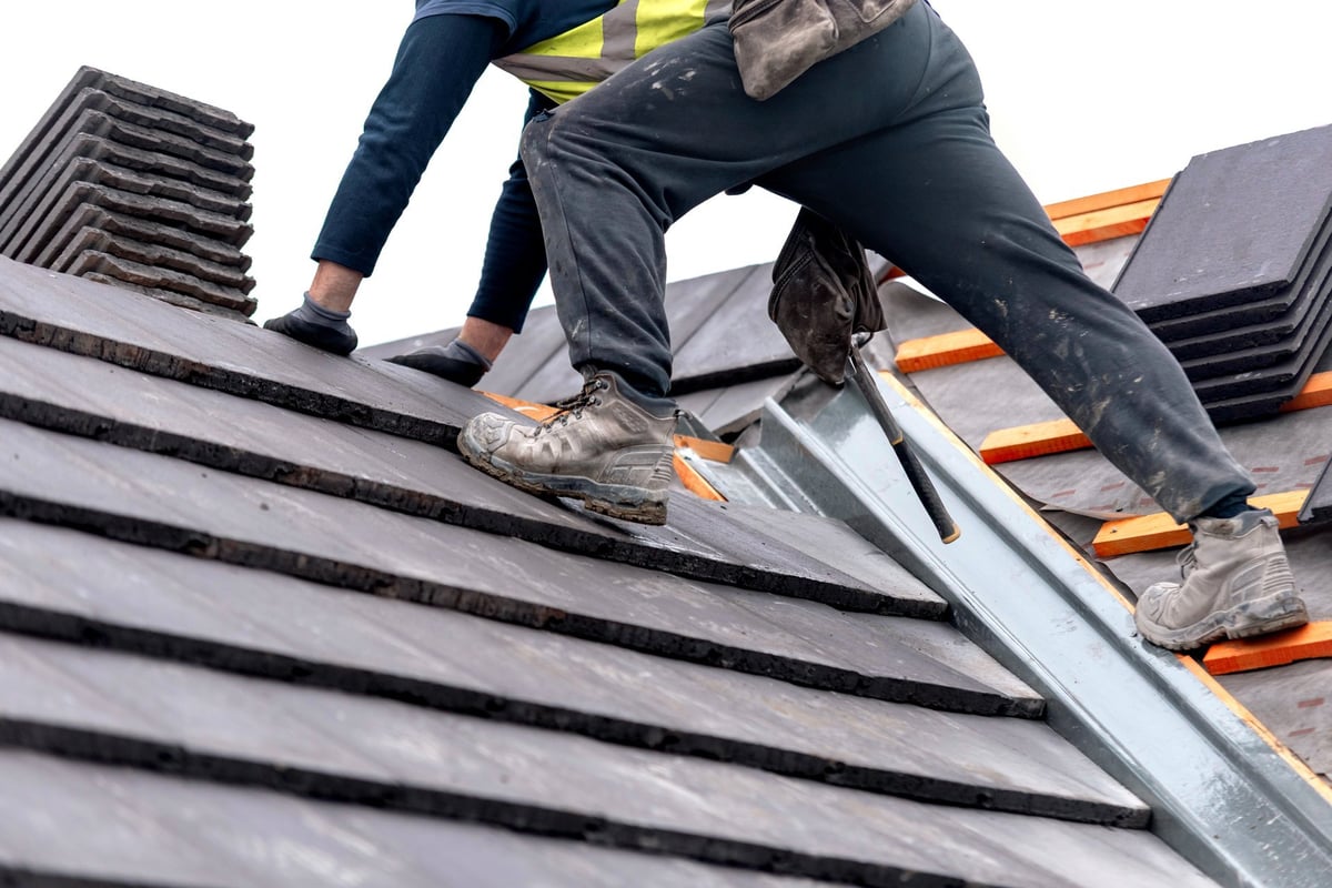 Roofing contractor working on a residential roof