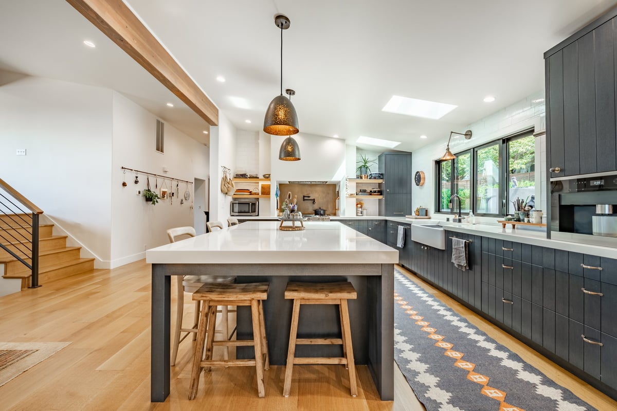 Modern remodeled kitchen with dark cabinetry and a large island